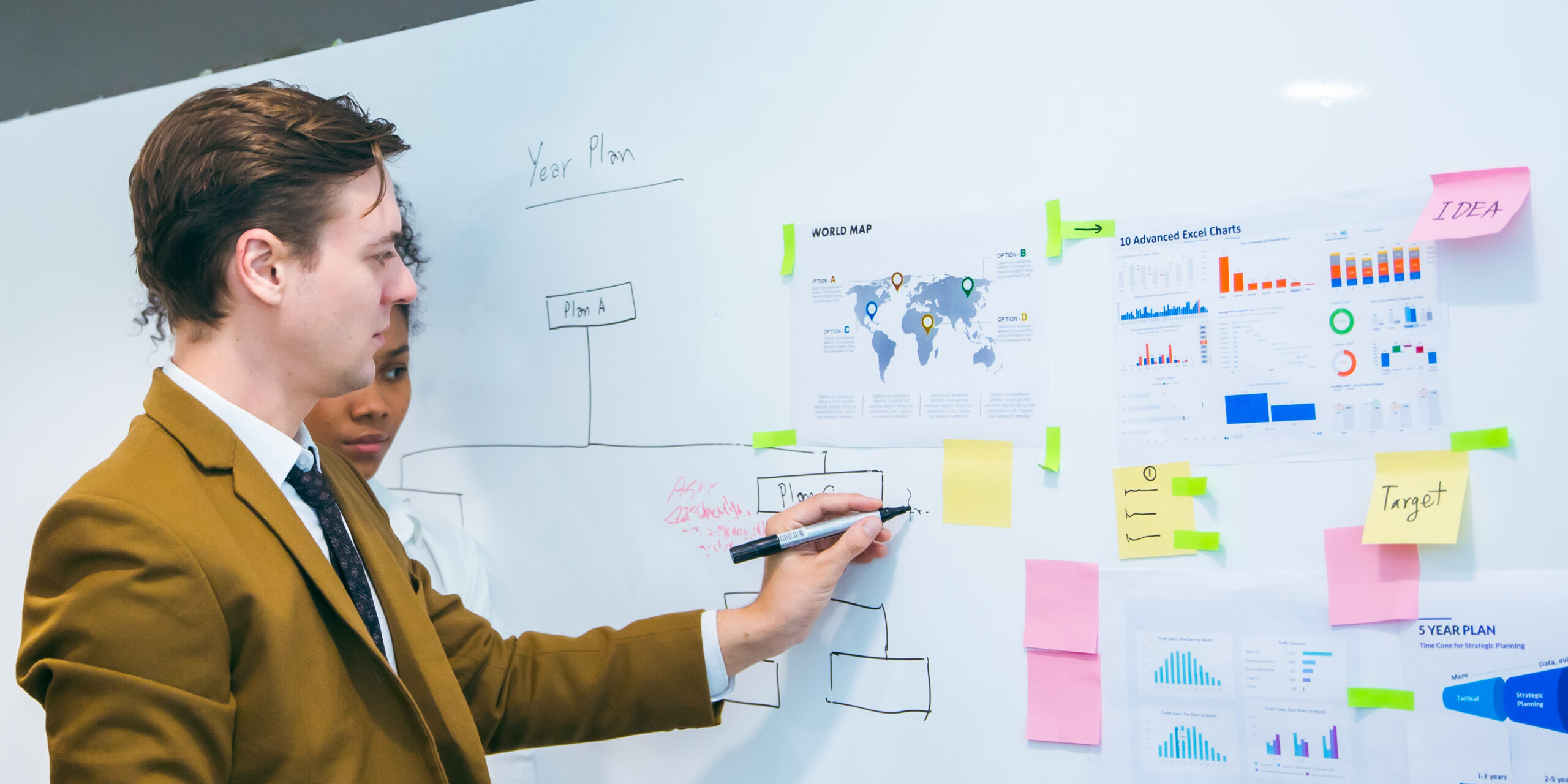 business team meeting with stats and review graphs of company target, goals or market research with data analysis. Above, table or paperwork report of growth, progress or startup performance analytics