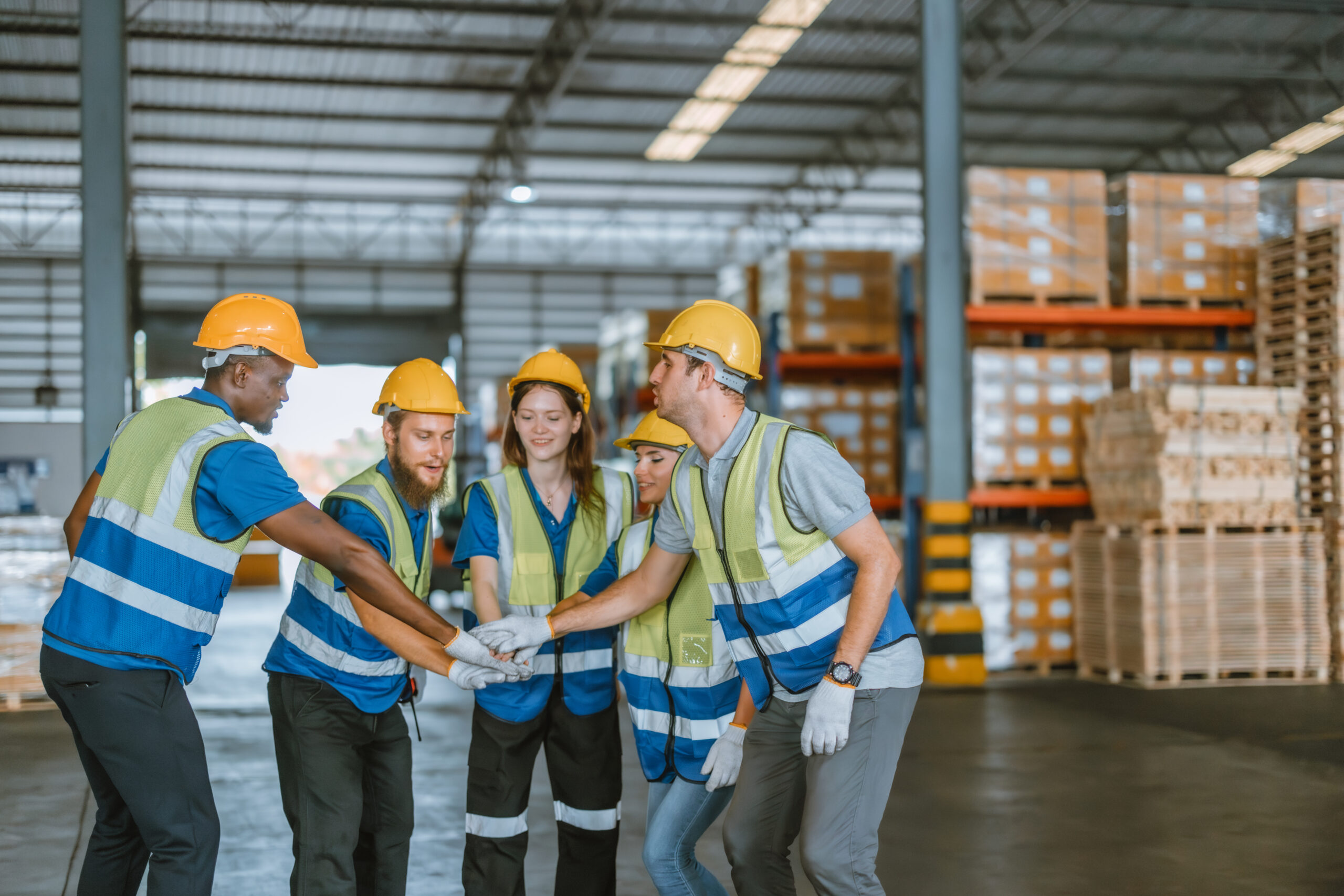 Multicultural warehouse staff creates logistical atmosphere that encourages empowerment, confidence. The collaborative and diverse team results in excellent performance and a strong sense of unity.